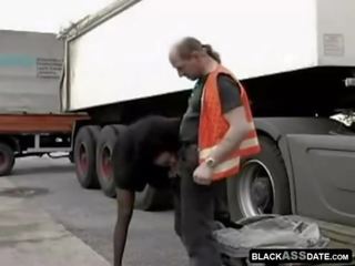 Black harlot riding on ripened truck driver outside